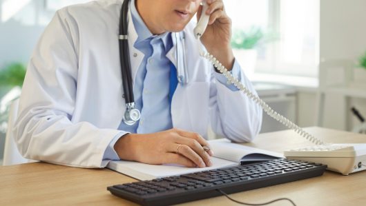Medical,Professional,Doctor,,Male,Nurse,At,Office,Desk,,Talking,On