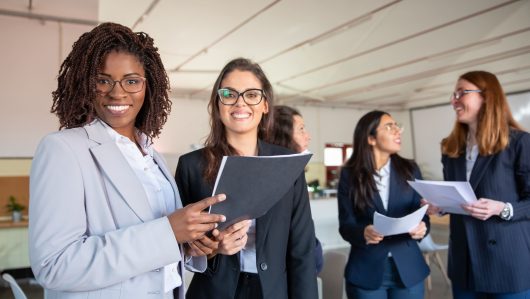 group-smiling-women-holding-paper-documents group-smiling-women-holding-paper-documents