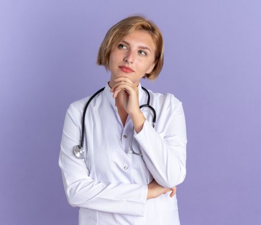 thinking-young-female-doctor-wearing-medical-robe-with-stethoscope-grabbed-chin-isolated-blue-background thinking-young-female-doctor-wearing-medical-robe-with-stethoscope-grabbed-chin-isolated-blue-background